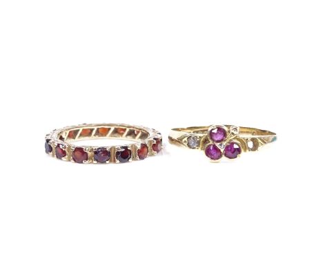 An 18ct gold ruby and diamond petal ring, 6.3mm, size Q, 2g, together with a 9ct garnet full eternity ring, setting height 2.