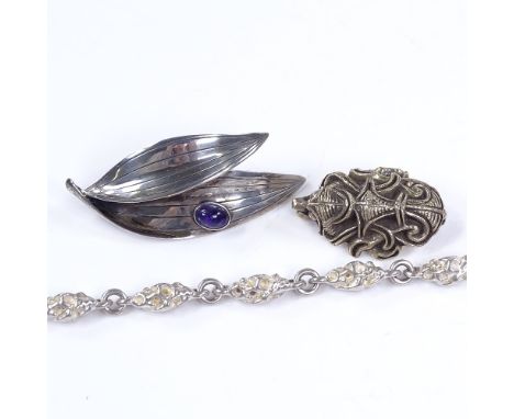 A Viking revival sterling silver brooch, by Frans Magnussen, a Swedish silver and amethyst leaf brooch, and a sterling silver