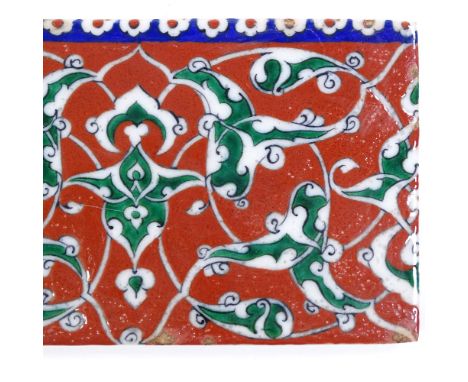 A Turkish Kutahya ceramic tile with painted decoration, length 21cm 