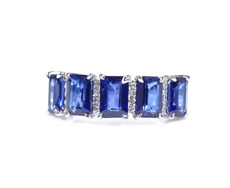 A 14ct white gold sapphire and diamond half-hoop ring, total emerald-cut sapphire content approx 3.43ct, total diamond conten