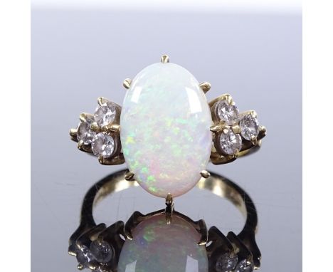 An 18ct gold opal and diamond trio ring, maker's marks KSK, hallmarks London 1987, setting height 16.1mm, size N, 5g 