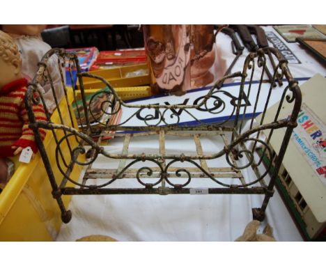 Vintage French toy doll's cot, ornate metal with original castors 