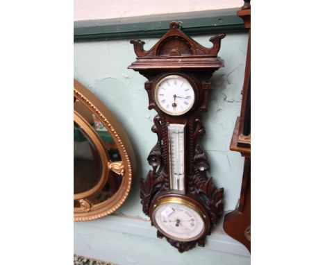 Victorian heavily carved banjo style barometer incorporating clock