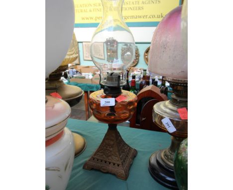 Heavy cast based oil lamp, with glass oil container and funnel
