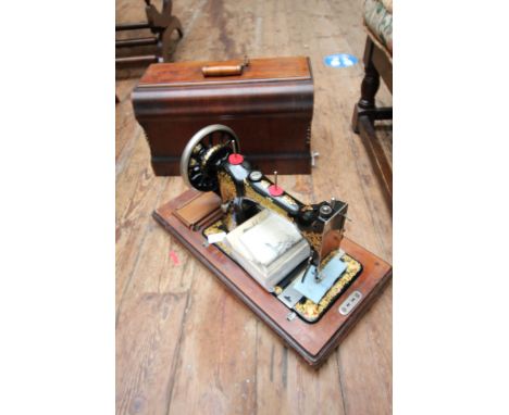 Vintage Jones family CS sewing machine in oak cabinet with accessories 