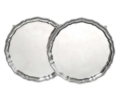 A Pair of Elizabeth II Silver Salvers, by Wakely and Wheeler, London, 1964, each shaped circular and on four ball and claw fe