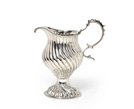 A George III Silver Cream-Jug, Maker's Mark ?R, London, 1769, spiral-fluted and on similarly decorated foot, with beaded scro