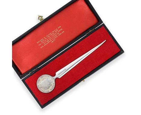 An Elizabeth II Silver Paper-Knife, by Stuart Devlin, London, 1977, with tapering blade. the terminal set with a medal celebr