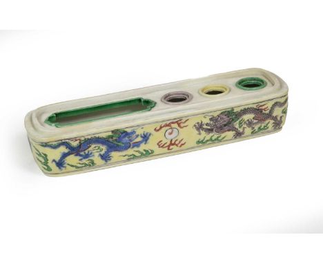 A Chinese Wucai Porcelain Pen Box, Kangxi, of rounded rectangular form with three circular and one rounded rectangular apertu