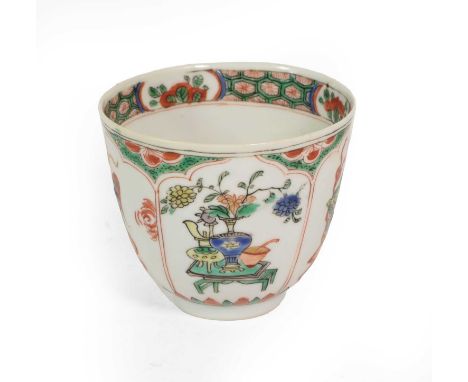 A Chinese Porcelain Tea Bowl, Kangxi, painted in famille verte enamels with auspicious objects and mythical beasts on tables 