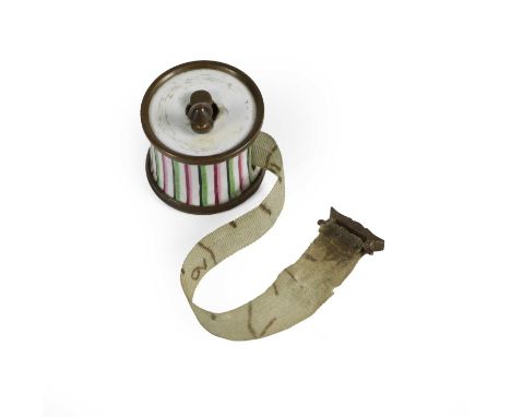 A South Staffordshire Enamel Cased Tape Measure, circa 1775, in the form of a drum with green and pink stripes, containing a 