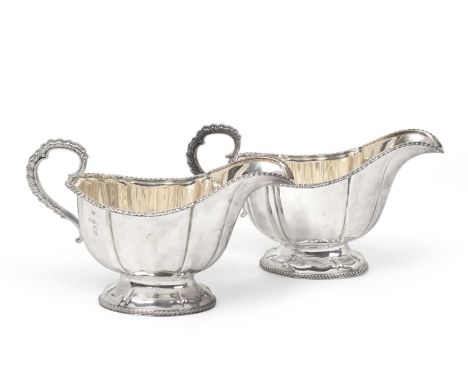 A Pair of Elizabeth II Silver Sauceboats, by Garrard and Co., Sheffield, 1953 and 1954, each fluted oval and on conforming fo