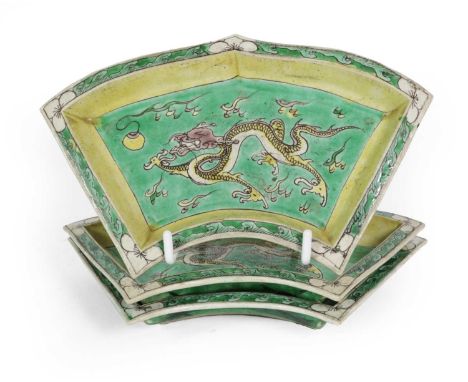 A Set of Three Chinese Porcelain Fan Shaped Sweetmeat Dishes, Kangxi, painted in famille verte enamels with dragons chasing t