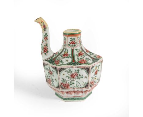 A Chinese Porcelain Ewer, Kangxi, of fluted hexagonal form with scroll spout, painted in famille verte enamels with panels of