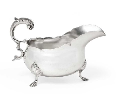 A Victorian Silver Sauceboat, by Edward Barnard and Sons Ltd., London, 1896, in the George III style, oval and on three shell