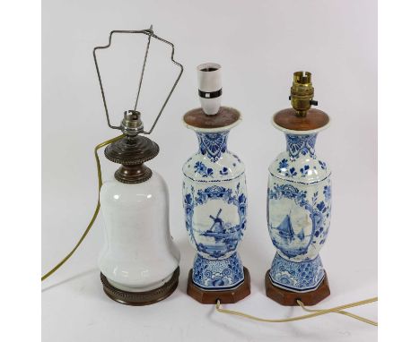 A Pair of Delft Vases, early 20th century, of baluster form, decorated in blue with canal scenes, 28cm high, mounted as lamp 