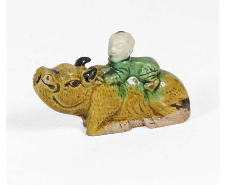 A Chinese Sancai Porcelain Water Dropper, Kangxi, modelled as a boy sitting on a recumbent water buffalo, 9cm longCondition r