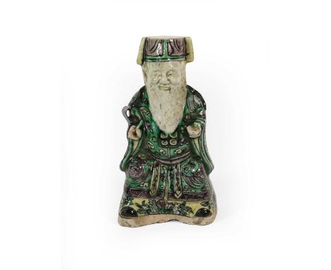 A Chinese Porcelain Figure on an Immortal, Kangxi period, as a seated bearded figure, decorated in famille verte enamels, 12c