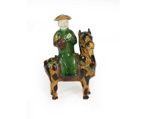 A Chinese Sancai Glazed Porcelain Figure Group, Kangxi, as a scholar on horseback, picked out in coloured glazes, 16cm highCo