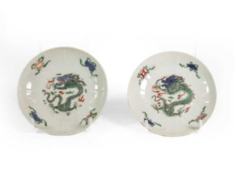 A Pair of Chinese Porcelain Small Dishes, Kangxi, of fluted circular form, painted in famille verte enamels with dragons chas