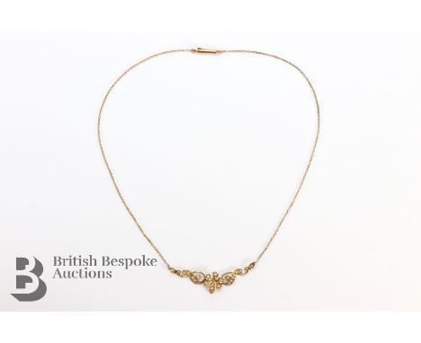 15ct gold and seed pearl pendant, suspended from a 15ct gold chain. The necklace including the drop measures 40cm, approx 5.5
