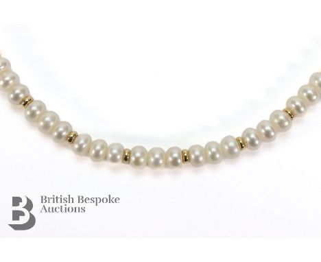 A button pearl and gold bead necklace, on a 9ct gold clasp. The necklace measures approx 50 cms, in a Scott's Jewellers prese