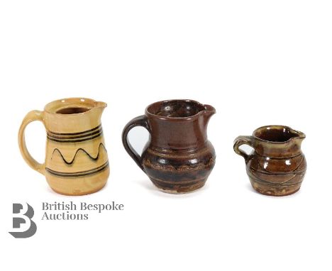 Patrick Groom (active 1947-1954) for Winchcombe Pottery, three jugs including an ochre slipware example with trailing decorat