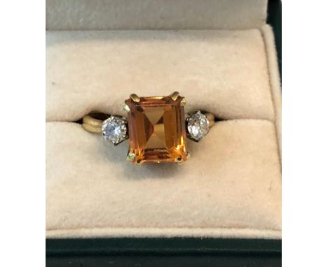 An 18ct gold yellow sapphire and diamond ring 4.70ct sapphire set with diamond each side weight 5g comes with valuation certi