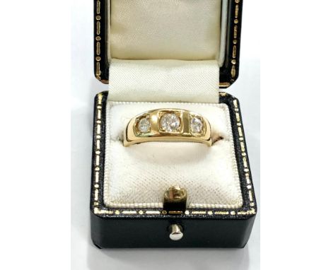 18ct Gold three stone diamond ring the central diamond measures approx 4mm dia weight of ring 6.4g 