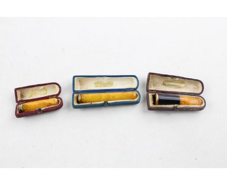 3 Assorted vintage amber stem cheroot holders w/ rolled gold banding 