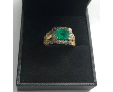 18ct gold diamond and emerald ring set with large central emerald that measures approx 7mm by 6.5mm with diamonds around 