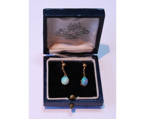 Pair of opal drop earrings, each oval opal dependant from a bead.CONDITION REPORT: Drop opals in gold claws. Drop opals in go
