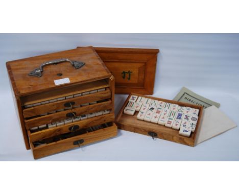 Chinese mahjong set (20th century) contained in a wooden export case with handle and five drawers enclosing assorted bone til