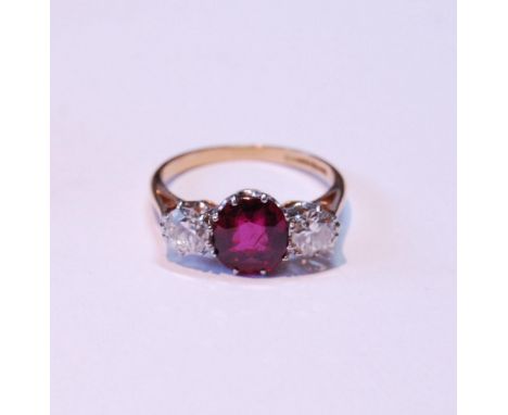 Three-stone ruby and diamond ring, the almost-circular ruby approximately 6mm x 7mm, with two old-cut brilliants, ‘18ct Plat’