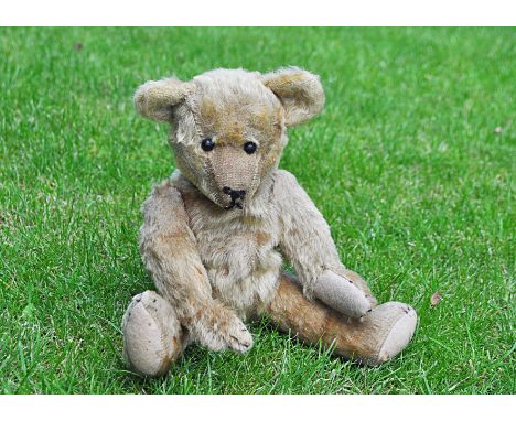 Ike an Ideal teddy bear circa 1908, with golden mohair, black boot button eyes, pronounced muzzle, remains of black stitched 