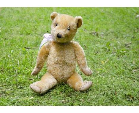 Oscar a Chiltern type teddy bear 1930s, with golden mohair, replaced clear and black glass eyes, pronounced muzzle, black sti