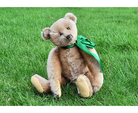 Muffin an early Steiff teddy bear circa 1908, with golden mohair, black boot button eyes, black stitched nose, mouth and claw