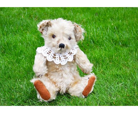 Bingie a Merrythought seated Bingie Baby teddy bear 1930s,  with light golden mohair, orange and black glass eyes, pronounced