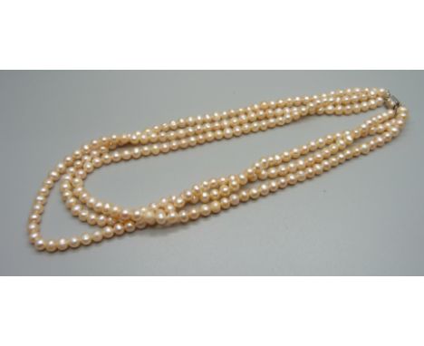 A  peach pearl necklace with silver clasp 