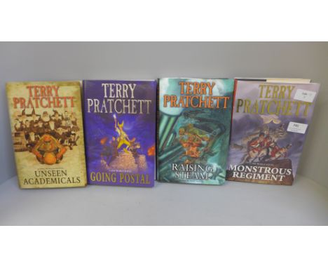 Four hardback first edition Discworld novels by Terry Pratchett; Monstrous Regiment, Going Postal, Unseen Academicals and Rai