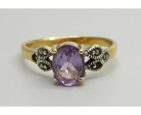 A silver gilt and amethyst ring, Q, lacking two marcasite 