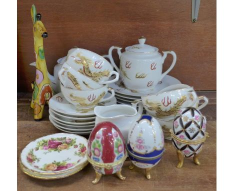 A Japanese tea set, three egg trinket pots, two Old Country Roses dishes and a model of a giraffe 