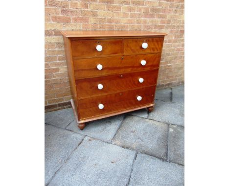 AN EDWARDIAN CHEST OF TWO SHORT AND THREE LONG DRAWERS  with ceramic handles, on turned supports, 114cm wide 61cm deep 111cm 
