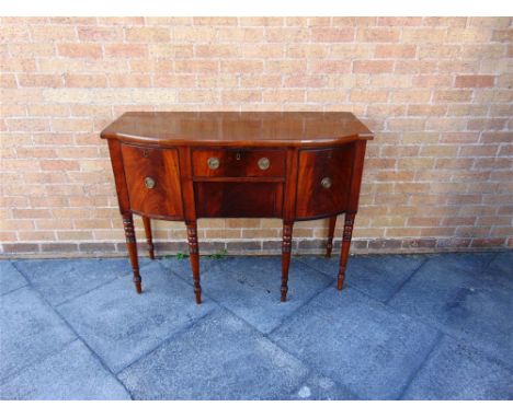 A WILLIAM IV MAHOGANY BOW FRONT SIDEBOARD  fitted with two drawers flanked by cellarette drawers, on ring turned supports, 12