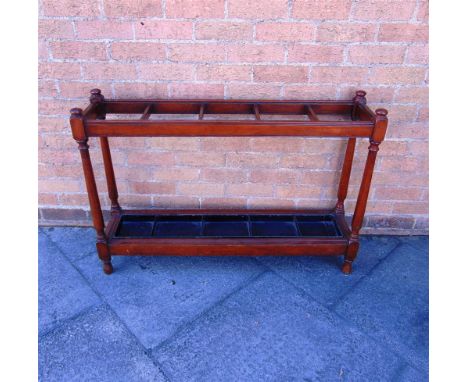 A LARGE MAHOGANY STICK / UMBRELLA STAND of country house proportions, with five compartments and a metal drip tray, 108cm wid