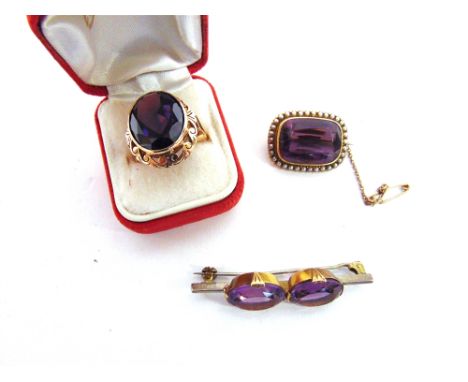 A VICTORIAN AMETHYST AND SEED PEARL BROOCH stamped '15ct', 2.7cm long, 8g gross; a ring set with a large synthetic stone, 12g