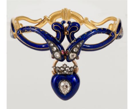 AN UNUSUAL VICTORIAN DOUBLE SERPENT DIAMOND, RUBY AND BLUE ENAMEL GOLD HINGED BANGLE  the confronting serpents each set with 
