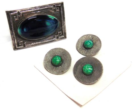 AN ARTS AND CRAFTS PEWTER BUCKLE  set with an oval ceramic panel, possibly Ruskin, 7.6cm by 5.2cm; with three paste buttons
