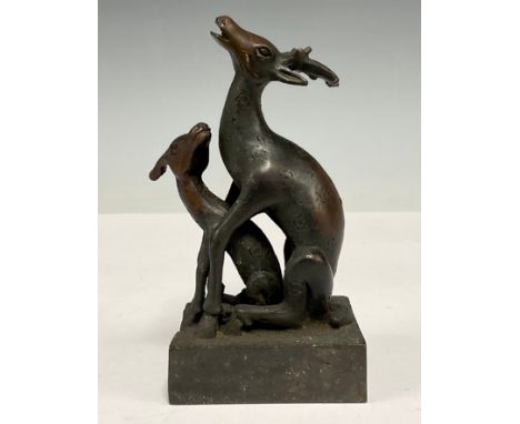 A Chinese patinated bronze desk seal, in the form of an interlocking deer and faun, 11.5cm high