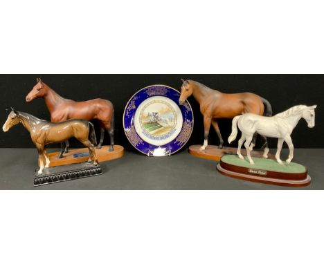 A Beswick Connoisseur model, of a racehorse, Troy, Racehorse of the Year 1979, wooden plinth, 29.5cm high; another, Arkle, Ch